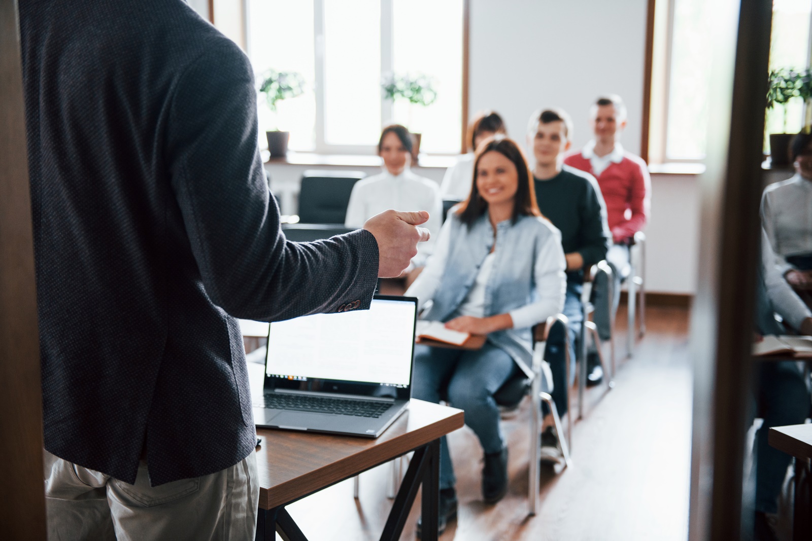 Group of people at business conference in modern classroom at daytime